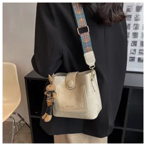 Retro women single shoulder crossbody bag with ethnic wide strap and cute rabbit pendant.