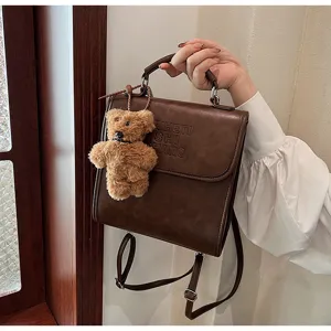 Vintage brown PU leather backpack with cute teddy bear pendant and chic embossed lettering.