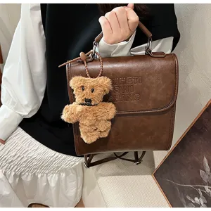 Vintage fashion casual backpack with cute bear pendant, premium PU leather material for students.