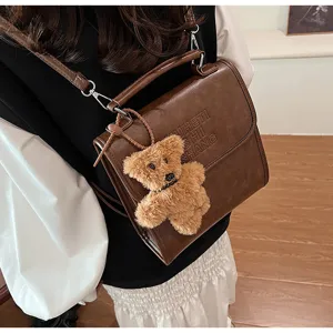 Vintage style casual brown PU leather backpack for women, cute bear pendant, stylish daily school bag.