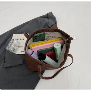 Detailed view of the large capacity retro tote bag interior compartments and daily styling scene.