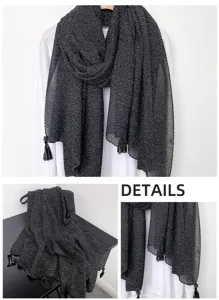Close-up details of the shimmering metallic scarf showing fine fabric texture and tassel trim.