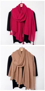 Detail view of women solid color tassel scarf hanging display, showing soft fabric and fringe.