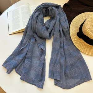 Blue shimmer plaid scarf detail, literary style autumn accessory, elegant textured fabric.
