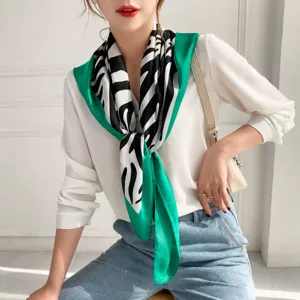 Vista detallada de panuelo cuadrado de seda para mujer con estampado de cebra y verde.