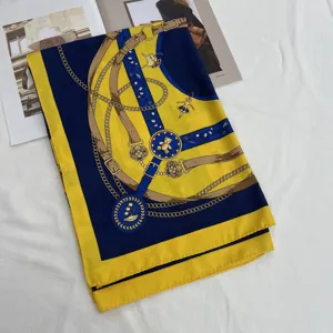 Chic blue and yellow silk square scarf with classic chain belt print, elegant summer accessory.