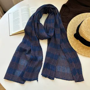 Blue brown plaid scarf detailed view, cotton linen texture, stylish autumn accessory.