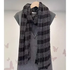 Women's black and silver plaid scarf, stylish winter warm knitted shawl accessory for daily wear.