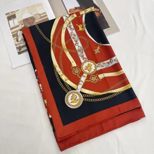 Silk square scarf detail view with luxury belt and chain print pattern, elegant style.