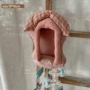 Fabric house hanging organizer detail, plaid roof and floral storage pocket with cute bow.