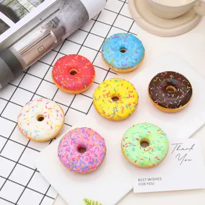 Close-up of colorful assorted PU simulation donuts with sprinkles on a white display plate