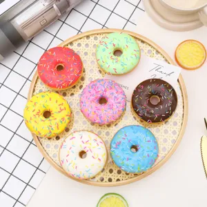 Detailed view of colorful PU simulation sprinkled donuts arranged on a bamboo tray prop.