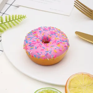 Close-up of realistic pink frosted donut model with colorful sprinkles