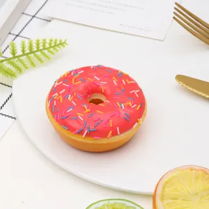 Close-up of a realistic PU pink frosted donut with colorful sprinkles