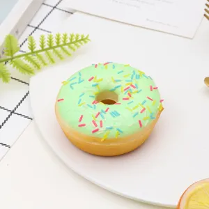 Close-up of a realistic PU donut model with green icing and colorful sprinkles