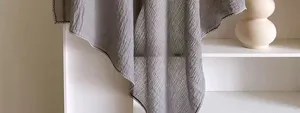 Detailed shot of a stylish solid gray cotton linen scarf, soft textured shawl for women.