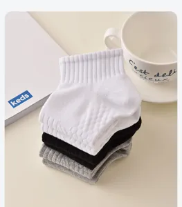 Detailed shot of breathable cotton short socks in white, black and grey with honeycomb cushioning.