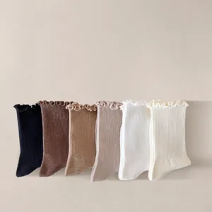 Ruffle trim mid-calf socks detail showing soft fabric and rich color assortment options.