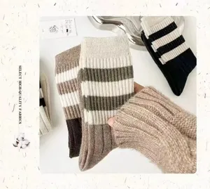 Close-up detail of vintage style striped knit socks, cozy autumn and winter casual hosiery.
