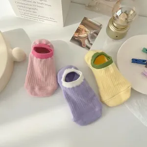 Close-up detail of women's colorful low-cut boat socks with soft ribbed texture and contrast trim.