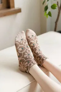 Close-up of vintage floral relief short socks showing delicate pattern and cozy fabric.