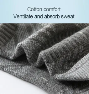 Grey sports socks close-up, breathable mesh fabric, cotton comfort, athletic wear detail view.