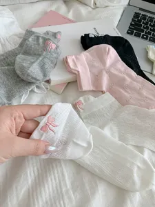 Cute women's short mesh socks featuring lovely bow embroidery, breathable and comfortable design.
