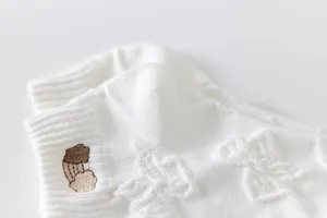 Close-up of white women's shallow boat socks with cute embroidered rainbow cloud and breathable knit.