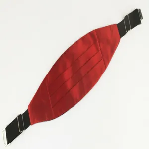Detail view of the red satin cummerbund with black elastic strap and silver adjustable buckle.