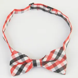 Detail shot of a children's red and black plaid bow tie with an adjustable strap and buckle.