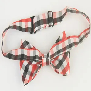 Children red black plaid bow tie with adjustable strap, classic tartan design accessory.
