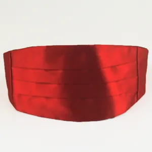 Red satin children formal cummerbund detail view, smooth shiny fabric with pleated design.