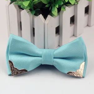 Men's light blue jacquard bow tie with silver dots and gold metal corners for formal wear.