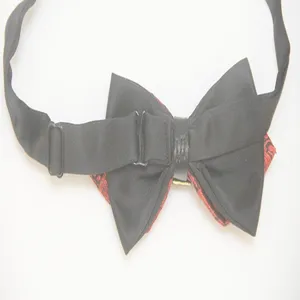 Detailed view of men's black and red bow tie with adjustable strap and central buckle.