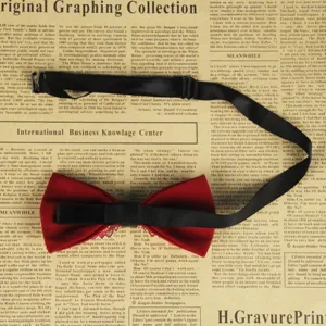 Men's red bow tie with adjustable black strap and rhinestone detail for wedding party.
