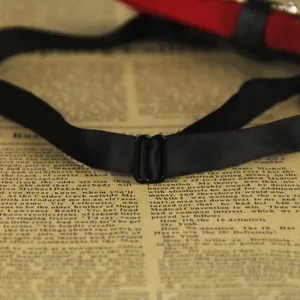 Black bow tie adjustable strap and metal buckle detail closeup for men formal wear.