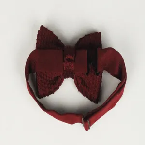 Detail view of a burgundy knitted men's bow tie with adjustable strap and metal buckle.