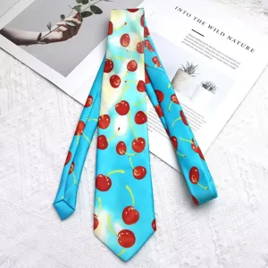 Close-up detail of a vibrant blue necktie featuring a cute red cherry pattern for stylish wear.