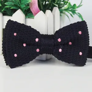 Classic black knitted bow tie with pink polka dots for men, perfect for weddings and events.