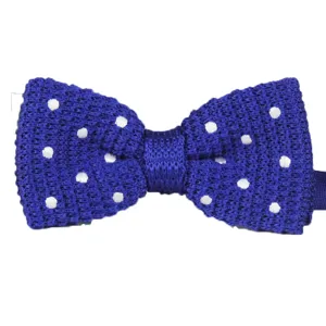 Men's blue knitted bow tie with white polka dots, stylish British style accessory for wedding.