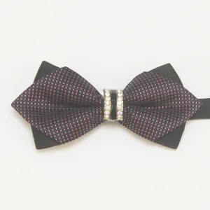 Detailed shot of a stylish men's pointed bow tie with sparkling rhinestones and check pattern.