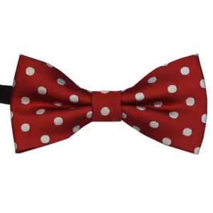Detailed close-up of a classic red and white polka dot bow tie, showcasing fine fabric texture.