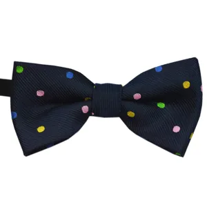 Detailed view of children's navy blue bow tie with colorful polka dots, cute and stylish.