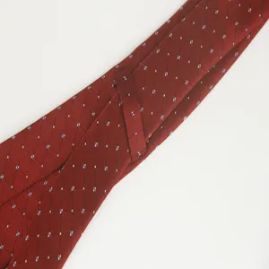 Close-up view of red patterned silk-like polyester business tie fabric texture detail