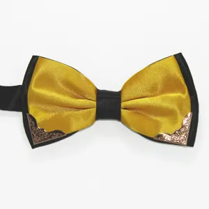 Close-up of a stylish two-tone bow tie with metallic corner details and smooth silk texture.