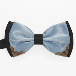 Detail view of stylish men blue satin bow tie featuring black trim and decorative metal corners.
