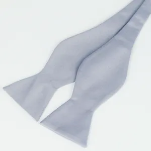 Light grey self-tie bow tie fabric detail, showing smooth texture and exquisite craft.