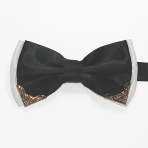 Detail view of men's double layer bow tie with metal corners and black white fabric.