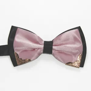 Close-up of pink and black bow tie with vintage metal corner decor for men's formal suit.