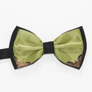 Detail shot of men's formal green and black bow tie featuring elegant metal corners.